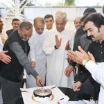 Defense Minister Khawaja Mohammad Asif cutting the birthday cake of former Minister Local Government Punjab Mohammad Manshaullah Butt at his residence Cantt
