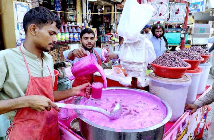 Vendors selling traditional summer drink at Pakistan Chowk during scorching hot weather in the city