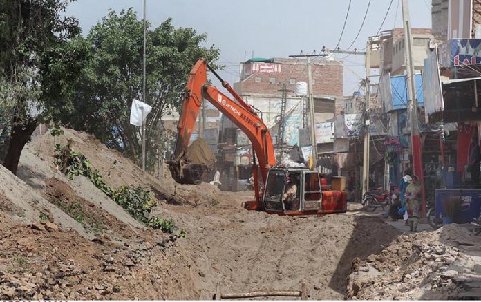 Construction work of sewerage line in process during development work in the city at Piran Ghaib Road