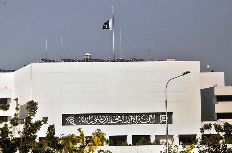 National flag flying half-mast on the Parliament House as Pakistan observe a day of mourning over tragic deaths of Pakistani migrants in the ship sinking incident near coast of Greece