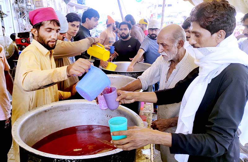 Vendors selling traditional summer drink at Pakistan Chowk during scorching hot weather in the city