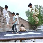 Children enjoying jump on trampoline on Eid al-Adha