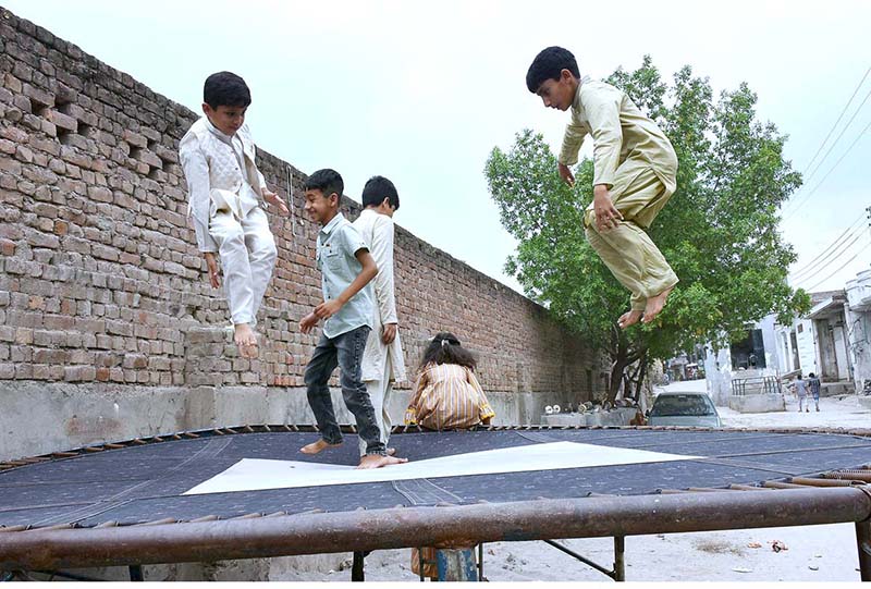 Children enjoying jump on trampoline on Eid al-Adha
