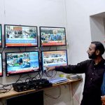 People listening the Federal Budget speech on TV