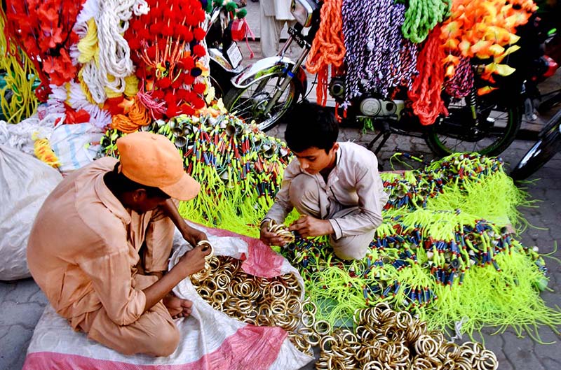 A vendor displaying the ornaments of sacrificial animals to attract customers at local market in connection with upcoming Eidul Azha