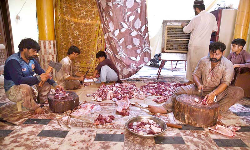 Butchers slaughtering sacrificial animal in a house on the 2nd day of Eid ul Azha