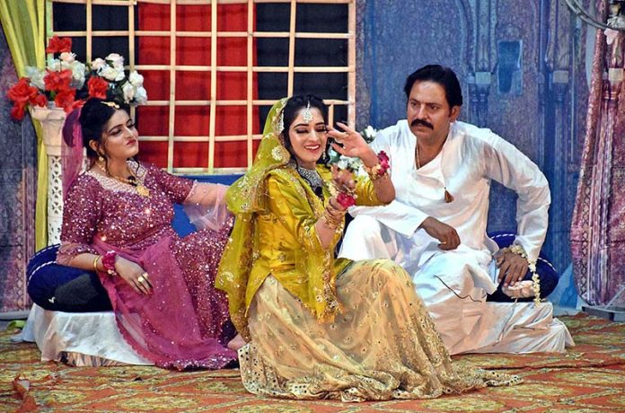 Artists performing in stage drama "Ghungroo” during Sindh Theatre Festival 2023 at ZA Bhutto Open Air Theater