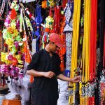 A vendor displaying the ornaments of sacrificial animals to attract customers at local market in connection with upcoming Eidul Azha