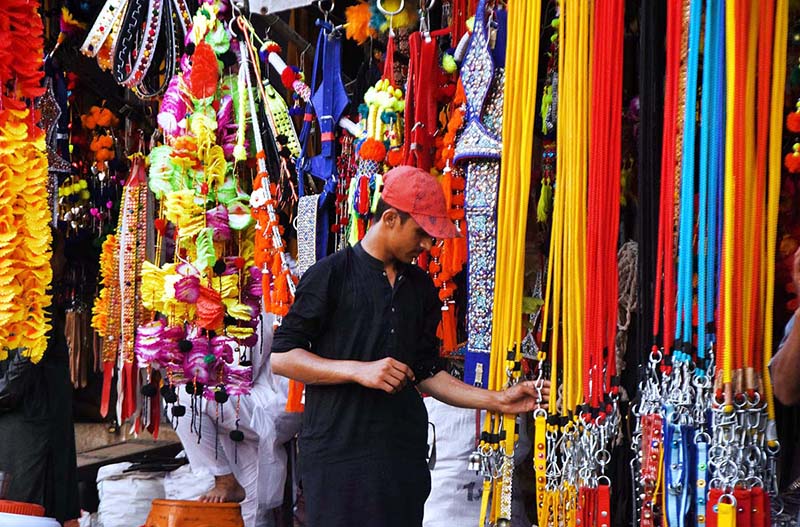 A vendor displaying the ornaments of sacrificial animals to attract customers at local market in connection with upcoming Eidul Azha