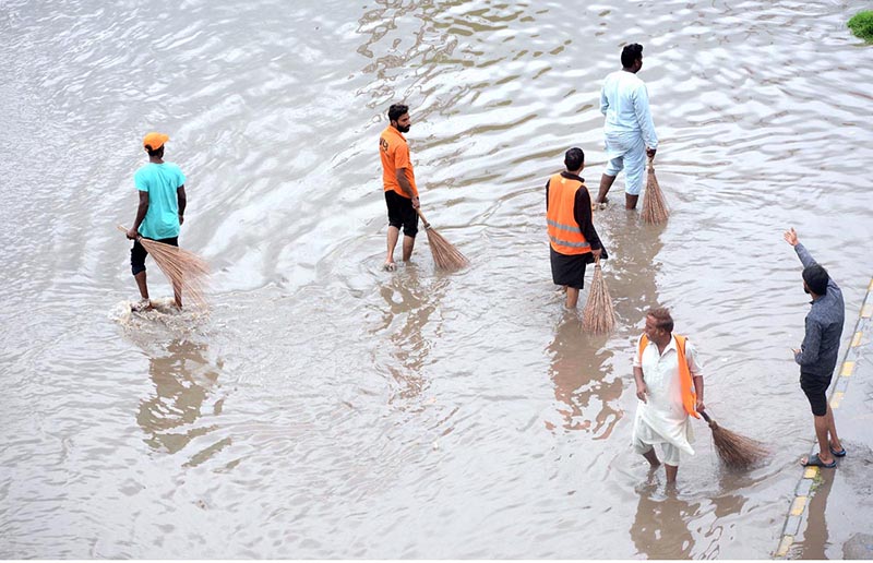A motorcyclist passing through water accumulated on road during heavy rain that experienced the city