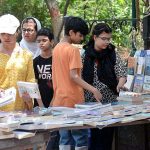 Family selecting old books on a roadside stall at Provincial Capital