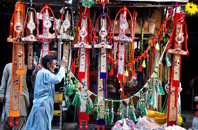 A vendor displaying the ornaments of sacrificial animals to attract customers at local market in connection with upcoming Eidul Azha