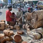 A vendor selling wooden blocks (to be used for cutting meat) on the eve of Eidul Azha.