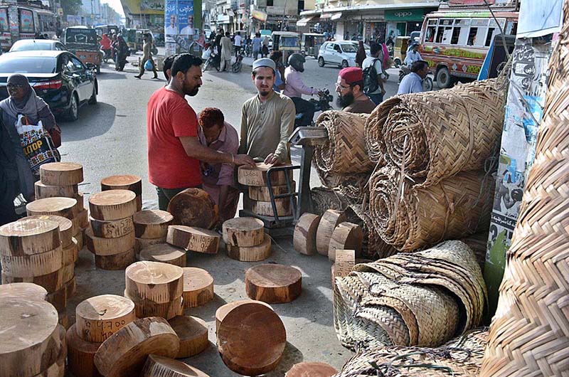 A vendor selling wooden blocks (to be used for cutting meat) on the eve of Eidul Azha.