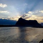 An attractive and eye catching view of sunrays peeping through clouds during sunset over the Chumik RCC bridge mountain