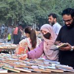 People busy in selecting and purchasing old books from roadside setup in Provincial Capital