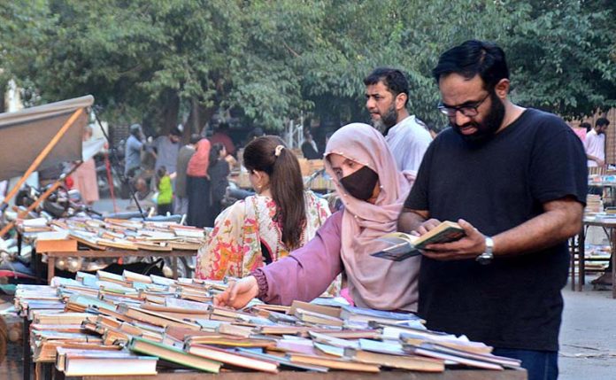 People busy in selecting and purchasing old books from roadside setup in Provincial Capital
