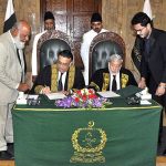 Honourable Mr. Justice Umar Ata Bandial, Chief Justice of Pakistan signing after administering the oath of office to Honourable Mr. Justice Iqbal Hameed-ur-Rehman, former Judge of the Supreme Court of Pakistan, as Chief Justice of the Federal Shariat Court at Supreme Court of Pakistan
