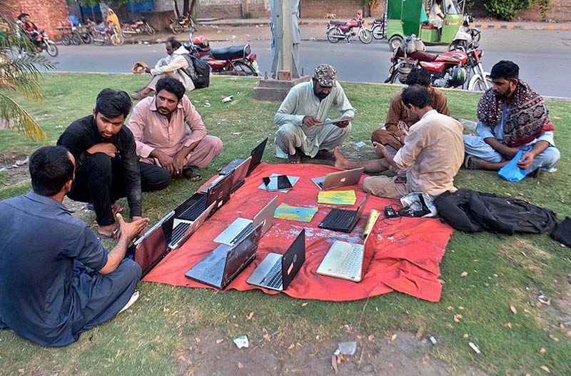 A street vendor displaying used Laptops to attract the customers at his roadside setup in Provincial Capital