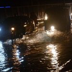 Vehicles are passing through rain water accumulated on road after heavy rain in the Provincial Capital