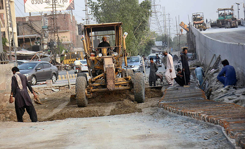 Labourers are busy in construction and development work of flyover to reduce the traffic problems at Feroz Pur Road