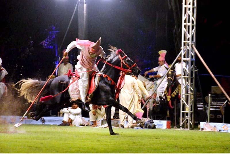 Horse rider hits the target during the all Pakistan Neza Bazi Competition at Lahore Polo Club