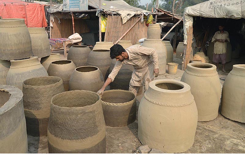 An artisan busy in making traditional oven (Tandoor) at his workplace in the outskirt area of Provincial Capital
