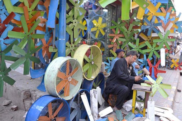 An electrician busy to repairing room-coolers at his workplace in the Provincial Capital