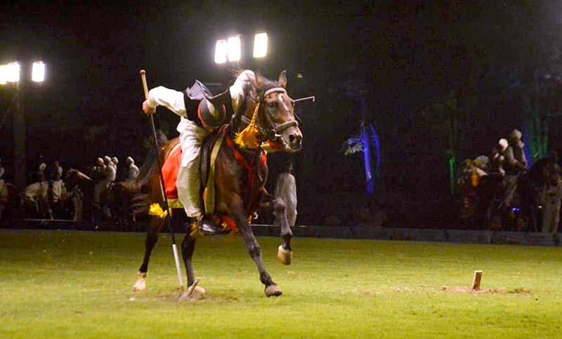 Horse rider hits the target during the all Pakistan Neza Bazi Competition at Lahore Polo Club