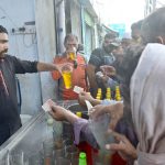 A vendor selling traditoinal summer drink (sandal) to customers during hot weather in Provincial Capital