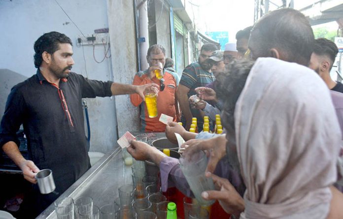 A vendor selling traditoinal summer drink (sandal) to customers during hot weather in Provincial Capital
