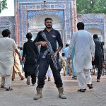 Security official standing high alert outside Shahi Eidgah during Eidul Azha prayers