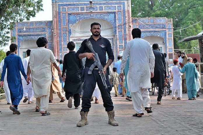 Security official standing high alert outside Shahi Eidgah during Eidul Azha prayers