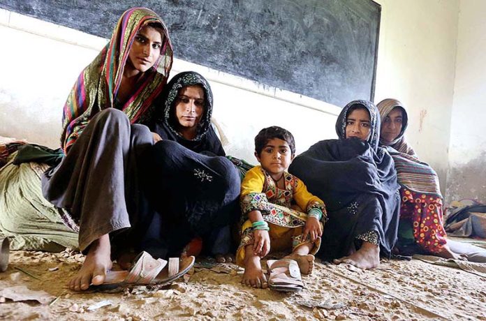 Family of Zero point area sitting on relief camp at Ahmed Rajo village before cyclone approaches the coast area