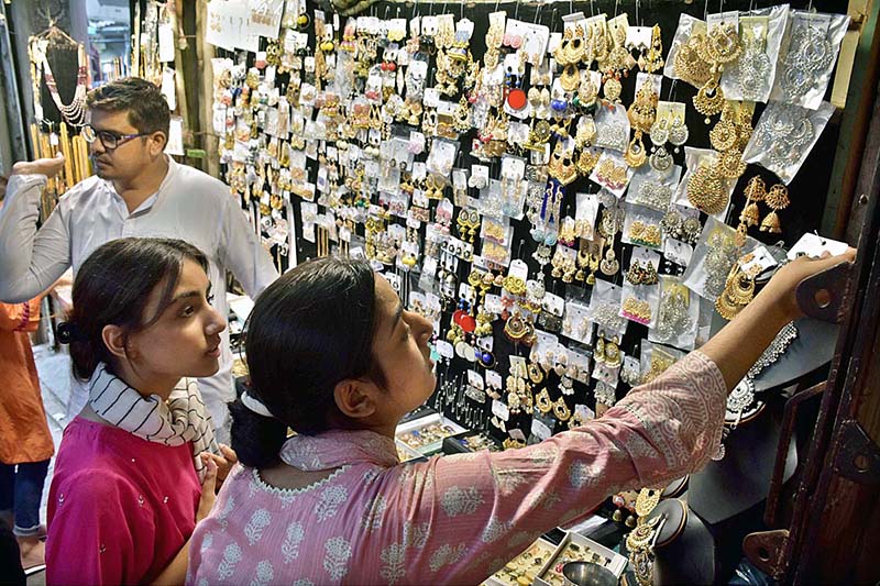 Girls selecting artificial jewelry for preparation of upcoming Eidul Azha at Reshamgali