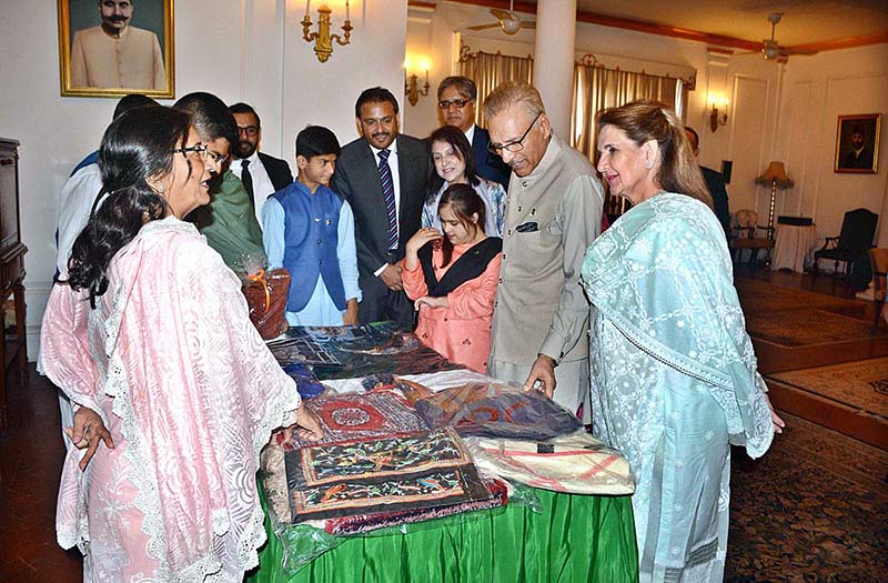 President Dr. Arif Alvi along with Begum Samina Arif Alvi watching handicrafts and artifacts prepared by special children of Association of Retarded Children School Karachi at Governor House