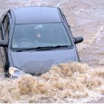 Vehicles are passing through rain water accumulated on road after heavy rain in the CITY