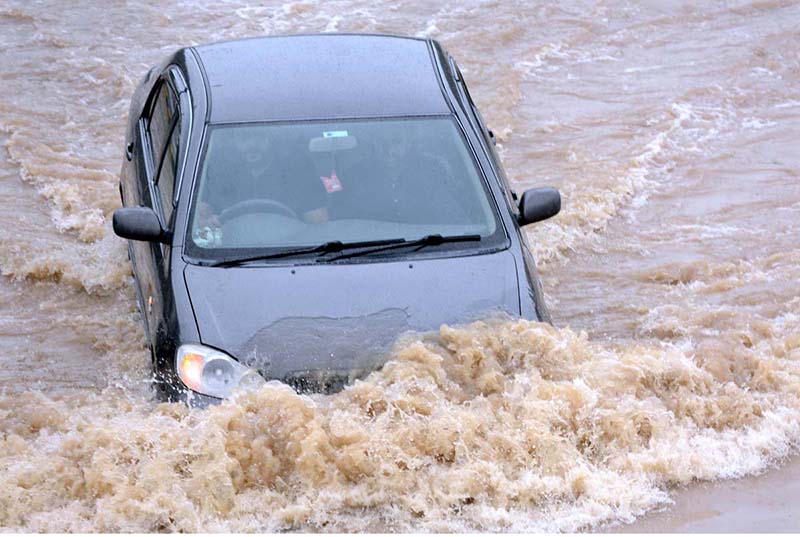 Vehicles are passing through rain water accumulated on road after heavy rain in the CITY