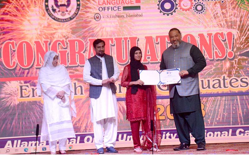 US Counsel General Lahore William K Makaneole gives away certificate to a girl during prize distribution ceremony of English Works Program at a local hotel