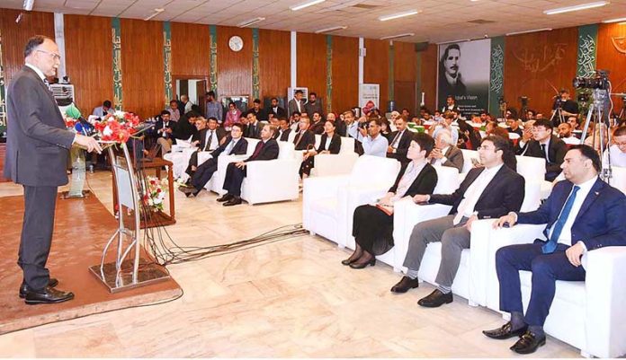 Federal Minister for Planning, Development and Reform Ahsan Iqbal addressing during Curtain-Raiser Event Celebrating 10Years of CPEC at Auditorium Ministry PD&SI