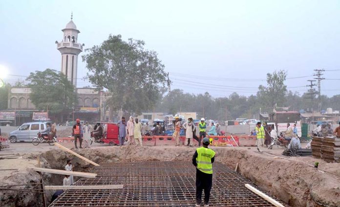 Labourers busy in construction work on six lane overhead bridge of Shahdara N-5 Crossing Imamia Colony Railway during development work in Provincial Capital