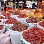 Women selecting and purchasing spices at Akbari Market