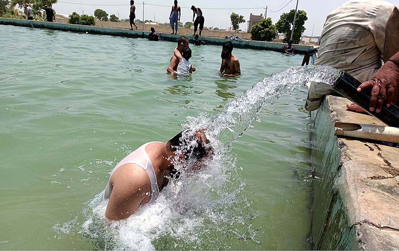 Youngster taking bath in a pool to get some relief from hot weather in the city
