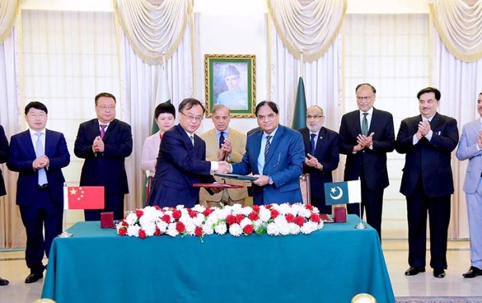 Wang Yongge, President of China National Nuclear Corporation Overseas Ltd (CNOS) and Muhammad Saeed Ur Rehman, Member Power, Pakistan Atomic Energy Commission (PAEC) signing an agreement for Unit 5 of Chashma Nuclear Power Plant (C-5). Prime Minister Muhammad Shehbaz Sharif, Ms. Pang Chunxue chargée d'affaires China, Shen Yanfeng, Vice President of China National Nuclear Corporation witnessed the signing ceremony
