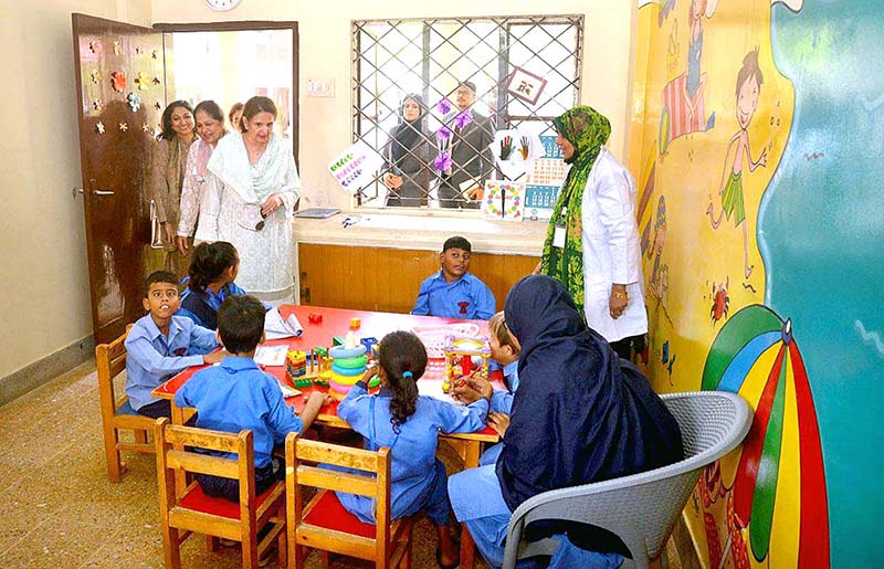 Begum Samina Arif Alvi visiting the society for the Rehabilitation of Special Children Centre