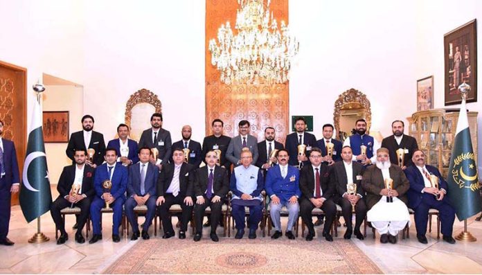 President Dr. Arif Alvi in a group photo with the winners of the Lahore Chamber of Commerce and Industry (LCCI) IT Excellence shields at Aiwan-e-Sadr