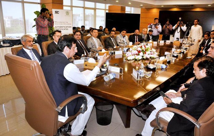Federal Minister for IT and Telecommunication Syed Amin Ul Haque chairing a meeting during the 'MoU Signing Ceremony of TDM to IP and Copper Wire to Optical Fiber Cable Migration of NTC Exchanges Phase 2' at National Telecommunication Corporation (NTC) Headquarters