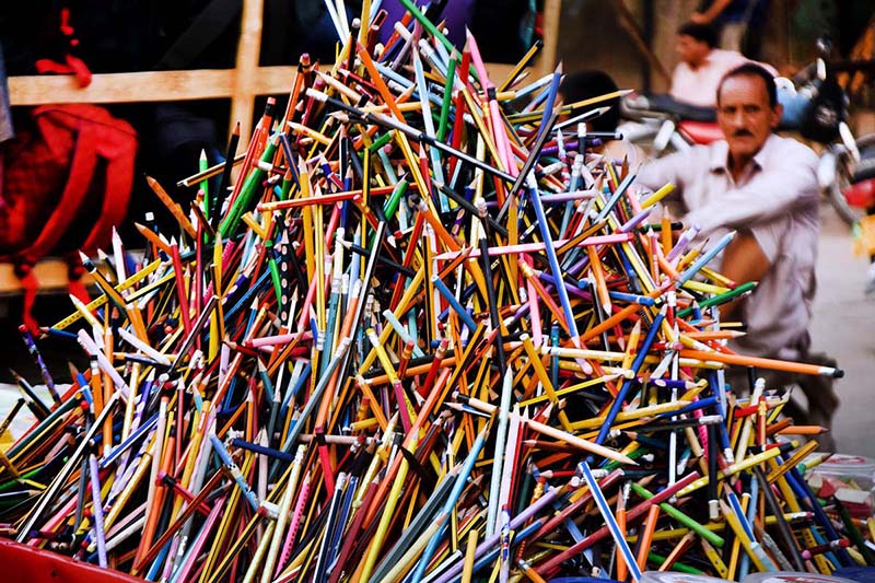 A vendor displaying the stationary items (colorful pencils) to attract the customers outside the Dehli Gate