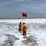 Officials placing red flag after alerts issued by the authorities regarding the effects of cyclone “Biparjoy” at the Hawksbay Beach