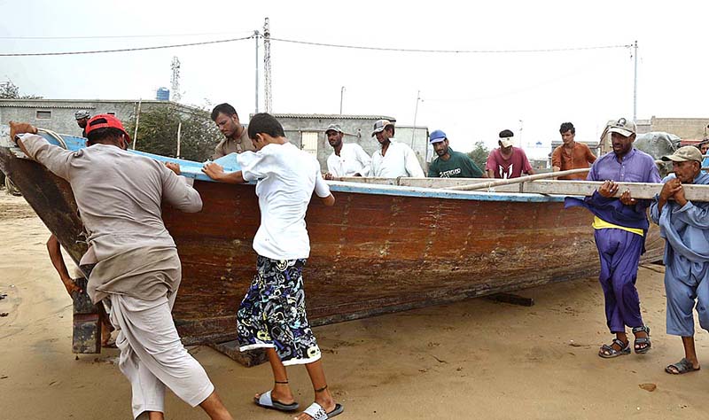 Fishermen moving their boat to safer place after alerts issued by the authorities regarding the effects of cyclone “Biparjoy